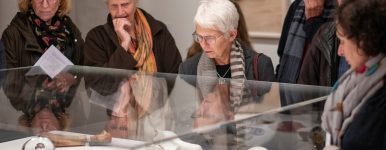 A group of people on a tour of the exhibition Kiki Smith: I am a Wanderer looking at Kiki Smith's small sculptures