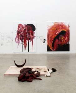 Three new works by Anish Kapoor. Two red visceral paintings on the wall and one painted sculpture on the floor