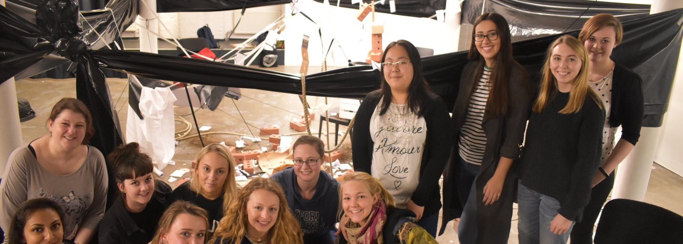 A group of 12 young people pose for a group photo in Modern Art Oxford's Creative Space.